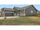 Charming single Gathering home featuring stone accents, a well-kept lawn and a two-car garage at 261 Hermosa St, Brighton, CO 80603