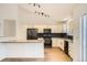 Bright, modern kitchen with white cabinetry, stainless steel appliances, and gray countertops at 261 Hermosa St, Brighton, CO 80603