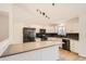 Bright, modern kitchen with white cabinetry, stainless steel appliances, and gray countertops at 261 Hermosa St, Brighton, CO 80603