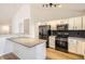 Bright, modern kitchen with white cabinetry, stainless steel appliances, and gray countertops at 261 Hermosa St, Brighton, CO 80603