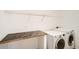 Laundry room featuring a front-loading washer and dryer with a countertop at 261 Hermosa St, Brighton, CO 80603