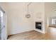 Bright living room featuring wood-look flooring, modern chandelier, and a cozy fireplace at 261 Hermosa St, Brighton, CO 80603