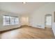 Bright living room with wood flooring and large windows, offering plenty of natural light at 261 Hermosa St, Brighton, CO 80603