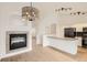 Open-concept living room featuring new wood-look flooring, a fireplace, and stainless steel kitchen appliances at 261 Hermosa St, Brighton, CO 80603