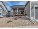 Backyard patio with stone landscaping and views of the home's architecture at 1104 Brocade Dr, Littleton, CO 80126