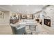 Finished basement featuring a white sectional sofa, fireplace, wet bar, and built-in nook at 1104 Brocade Dr, Littleton, CO 80126
