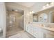 Modern bathroom showcasing a walk-in glass shower, dual vanities, and neutral color palette at 1104 Brocade Dr, Littleton, CO 80126