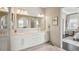 Beautiful bathroom with a double vanity, large mirror, and plenty of cabinet space at 1104 Brocade Dr, Littleton, CO 80126