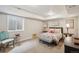 Bright bedroom features a comfortable bed, seating, and decor at 1104 Brocade Dr, Littleton, CO 80126