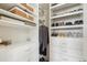 Custom walk-in closet featuring ample shelving, drawers, and hanging space for organized storage at 1104 Brocade Dr, Littleton, CO 80126