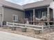 Home with a covered porch, rock landscaping, and stone pillars at 1104 Brocade Dr, Littleton, CO 80126
