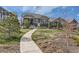Charming one-story home featuring a landscaped front yard and a winding concrete walkway at 1104 Brocade Dr, Littleton, CO 80126