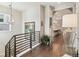 Bright hallway with hardwood floors, stylish lighting, and a view to the dining area at 1104 Brocade Dr, Littleton, CO 80126