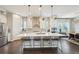 Bright kitchen with large island, pendant lights, and stainless-steel appliances at 1104 Brocade Dr, Littleton, CO 80126