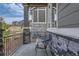 Cozy front porch with stone pillars and decorative chair at 1104 Brocade Dr, Littleton, CO 80126