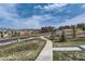 A neighborhood street with homes and a curving sidewalk at 1104 Brocade Dr, Littleton, CO 80126