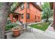 Charming backyard patio featuring outdoor seating and manicured lawn and red brick exterior at 1401 N Franklin St # 2, Denver, CO 80218