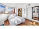 Sunlit bedroom with hardwood floors, built in bookcase, and a large window at 1401 N Franklin St # 2, Denver, CO 80218