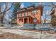 Charming two-story red brick home with a covered porch and a blue picket fence at 1401 N Franklin St # 2, Denver, CO 80218