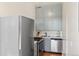 Well-lit kitchen featuring stainless steel appliances and stylish blue-grey cabinetry at 1401 N Franklin St # 2, Denver, CO 80218