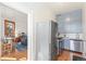 Modern kitchen featuring stainless steel appliances and blue cabinets, with a view of the living room at 1401 N Franklin St # 2, Denver, CO 80218