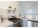 Galley kitchen featuring stainless steel appliances, modern countertops, and overhead shelving at 1401 N Franklin St # 2, Denver, CO 80218