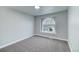 Charming bedroom with an arched window and grey carpet at 16521 E Easter Way, Foxfield, CO 80016