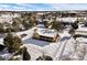 Aerial view of home with fenced backyard, mature trees, and snow-covered ground at 6834 Hillside Way, Parker, CO 80134