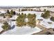 Aerial view of a snow-covered property surrounded by mature trees and expansive views at 6834 Hillside Way, Parker, CO 80134