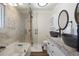 Spa-like bathroom boasting double sinks, soaking tub, glass shower, and marble countertops, with hardwood floors at 6834 Hillside Way, Parker, CO 80134