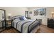 Cozy bedroom featuring a wrought iron bed, hardwood floors, and a bright window with decorative mullions at 6834 Hillside Way, Parker, CO 80134