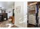 Dressing room with a vanity area and walk-in closet featuring built-in shelving and drawers at 6834 Hillside Way, Parker, CO 80134