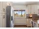 Bright kitchen with modern stainless steel refrigerator and cabinets at 6834 Hillside Way, Parker, CO 80134