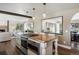 Kitchen island featuring bar stool seating, gas cooktop and integrated oven and microwave at 6834 Hillside Way, Parker, CO 80134