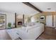 Inviting living room showcasing a classic brick fireplace, hardwood floors, and large window, with comfortable seating at 6834 Hillside Way, Parker, CO 80134