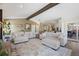 Open concept living room featuring modern neutral decor, hardwood floors, and a seamless flow into the kitchen at 6834 Hillside Way, Parker, CO 80134