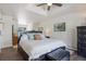 Spacious main bedroom with hardwood floors and a tray ceiling, with a peek into a sitting room at 6834 Hillside Way, Parker, CO 80134