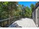 Wide wooden deck overlooking a yard with lush green foliage at 10411 Dowdle Dr, Golden, CO 80403