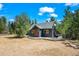 The exterior of this residence is distinguished by its natural wood accents and cozy deck at 10411 Dowdle Dr, Golden, CO 80403
