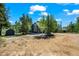 Exterior view of property with shed, blue skies, and dirt driveway at 10411 Dowdle Dr, Golden, CO 80403
