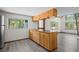 Kitchen island features custom wood cabinets, bar stool seating, and hardwood floors at 10411 Dowdle Dr, Golden, CO 80403