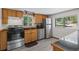 Kitchen features stainless steel appliances, wood cabinets, and hardwood floors at 10411 Dowdle Dr, Golden, CO 80403