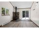 Living area featuring a wood-burning stove, sliding door access to deck, and laminate floors at 10411 Dowdle Dr, Golden, CO 80403