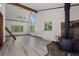 Bright and open living space with high ceilings, laminate floors, and a wood-burning stove at 10411 Dowdle Dr, Golden, CO 80403