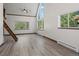 Bright living room featuring a vaulted ceiling, ceiling fan, a loft, and large windows at 10411 Dowdle Dr, Golden, CO 80403