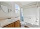 Bright bathroom featuring a shower-tub combination with a toilet and vanity with an oval mirror at 15614 E 51St Pl, Denver, CO 80239