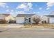 Quaint home featuring a front porch, single car garage, and manicured lawn at 15614 E 51St Pl, Denver, CO 80239