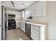 Well-lit kitchen with white cabinets, stainless steel appliances, and a window over the sink at 15614 E 51St Pl, Denver, CO 80239