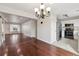 Open-concept living room flowing into a modern kitchen, featuring hardwood floors and neutral paint at 15614 E 51St Pl, Denver, CO 80239