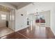 Bright living room with hardwood floors transitions to the kitchen with a sliding glass door to the backyard at 15614 E 51St Pl, Denver, CO 80239